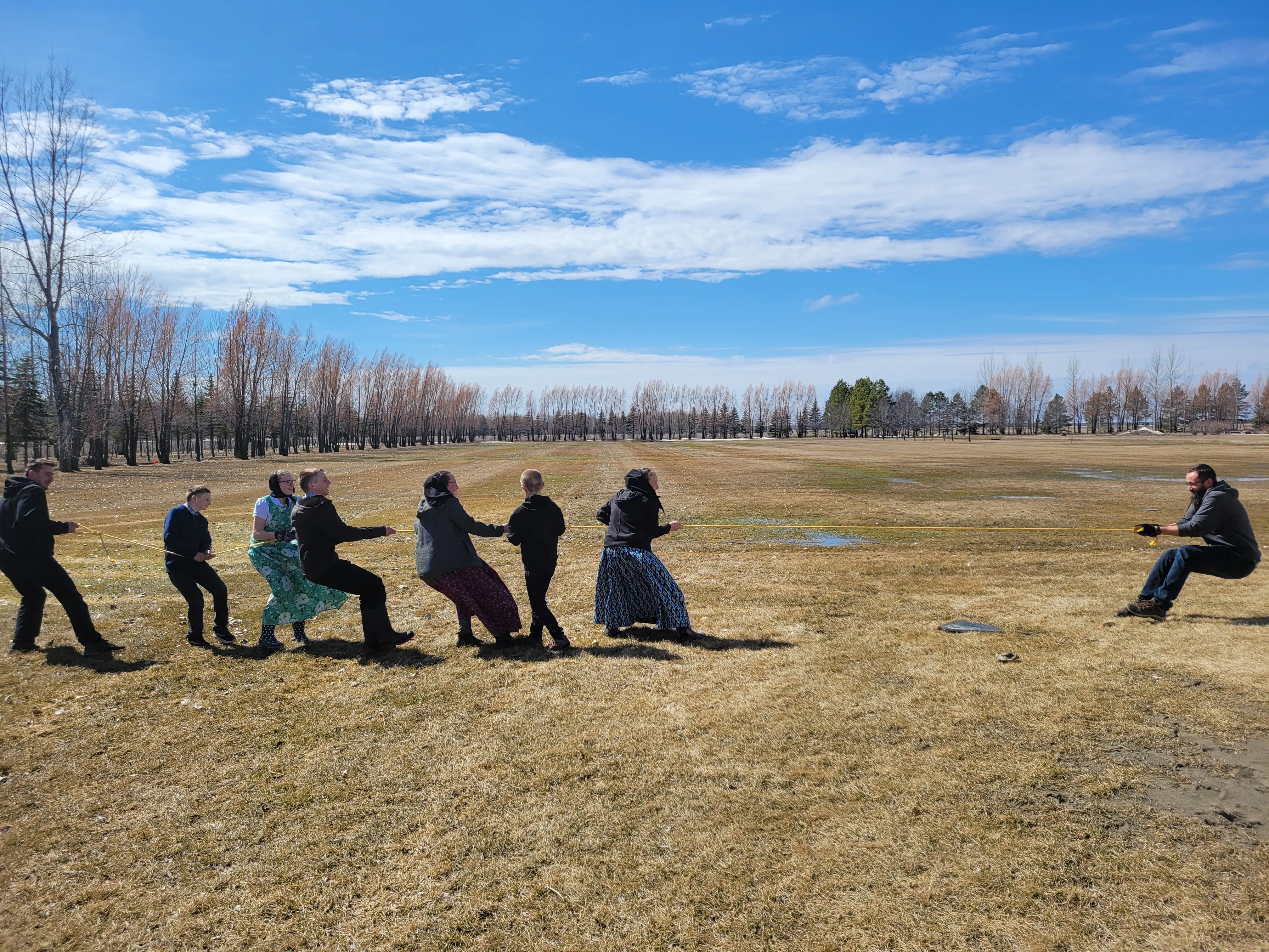 Students versus a teacher in a tug-of-war activity